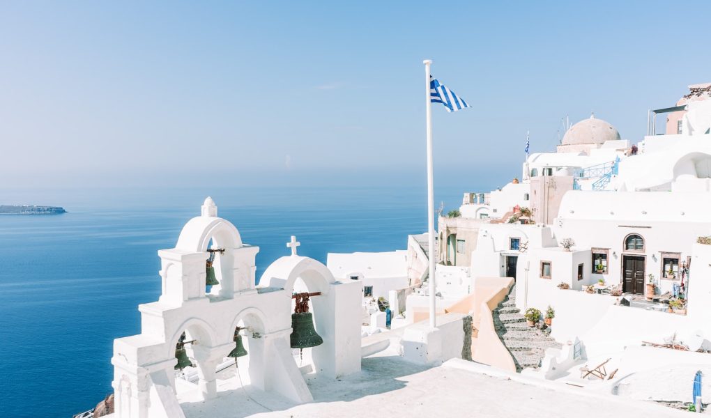 white concrete building near body of water during daytime